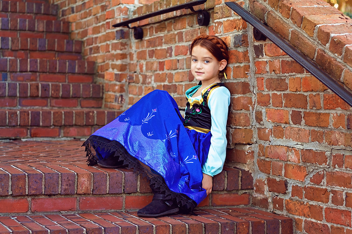 Frozen Theme Shoot Anna sitting on stairs.jpg