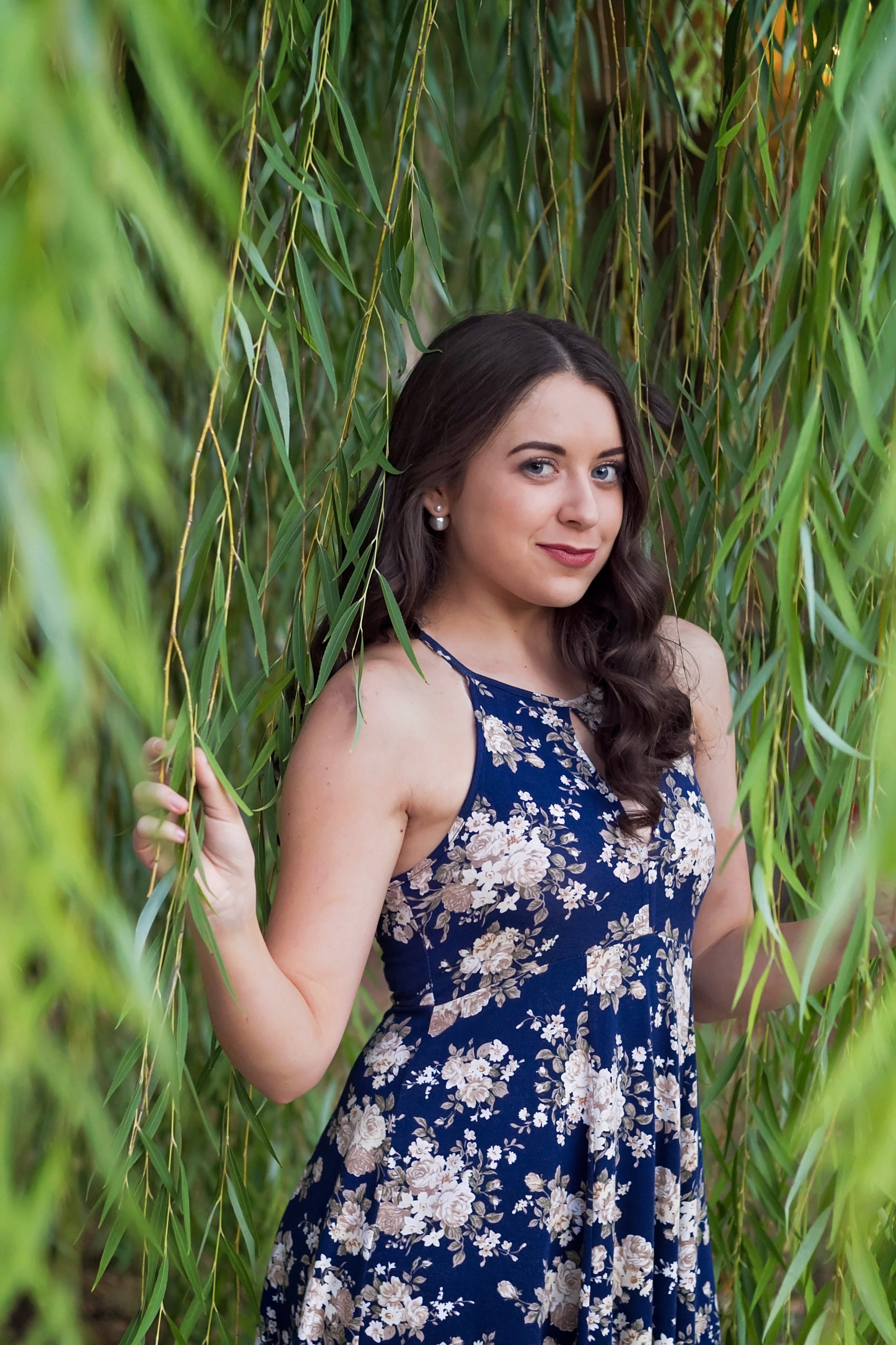 Senior Girl in Blue dress standing in a willow.jpg