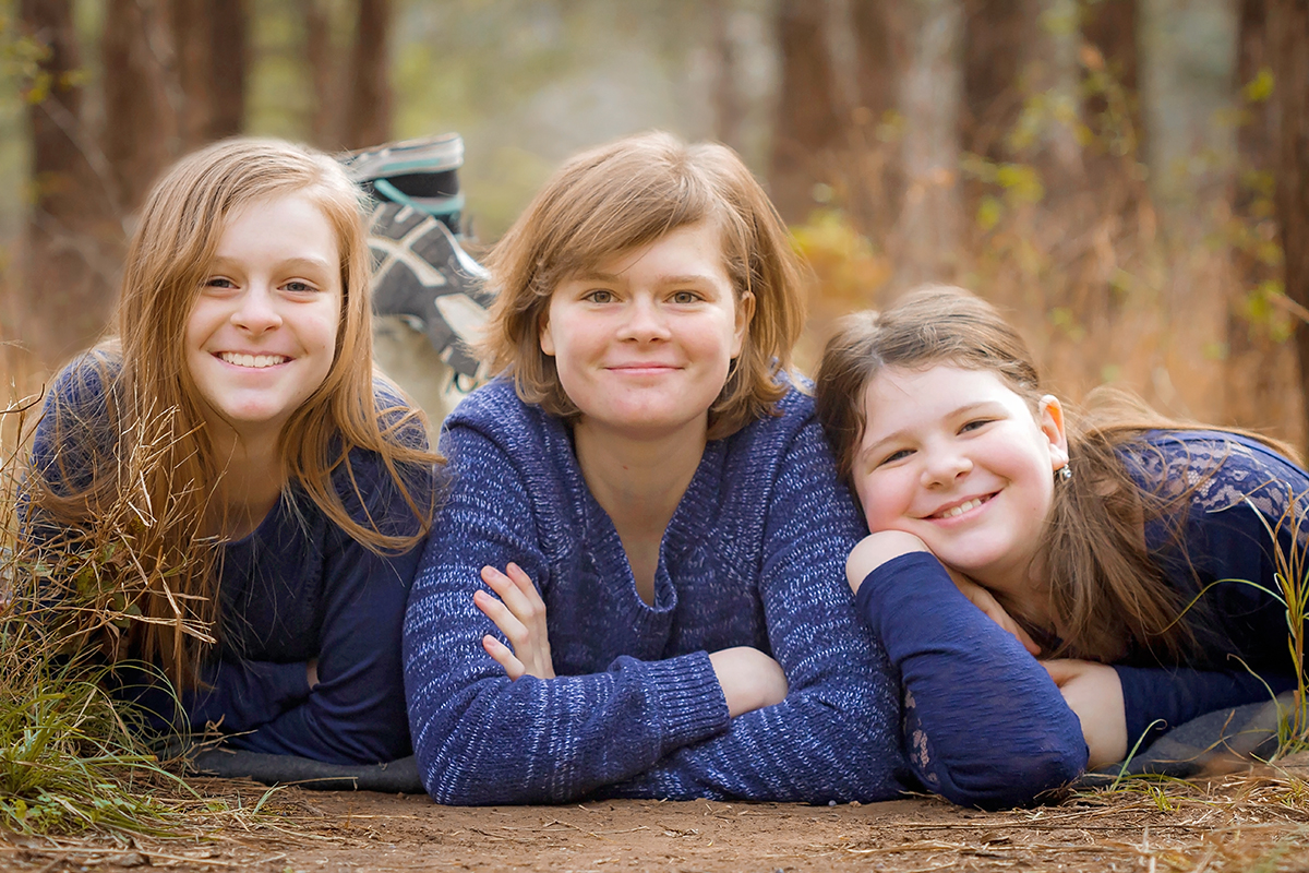 3 Sisters laying in the forest.jpg