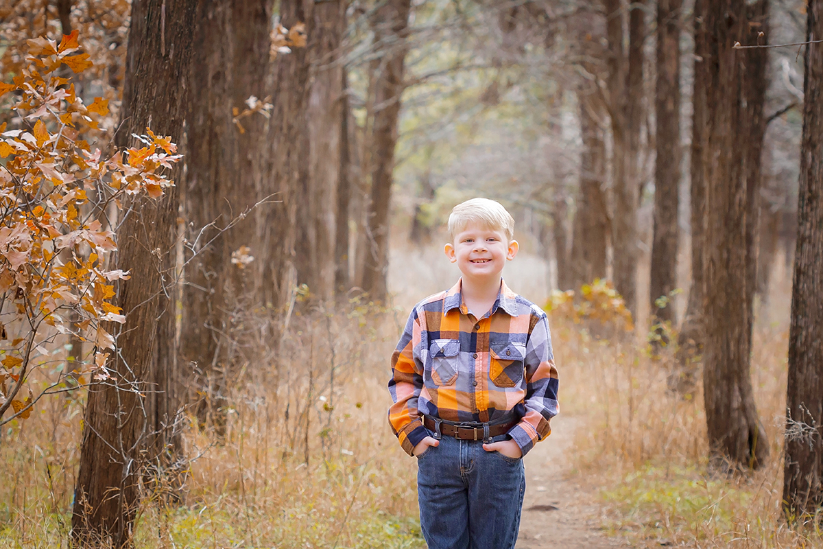 Little Boy in Plaid standing in forest.jpg