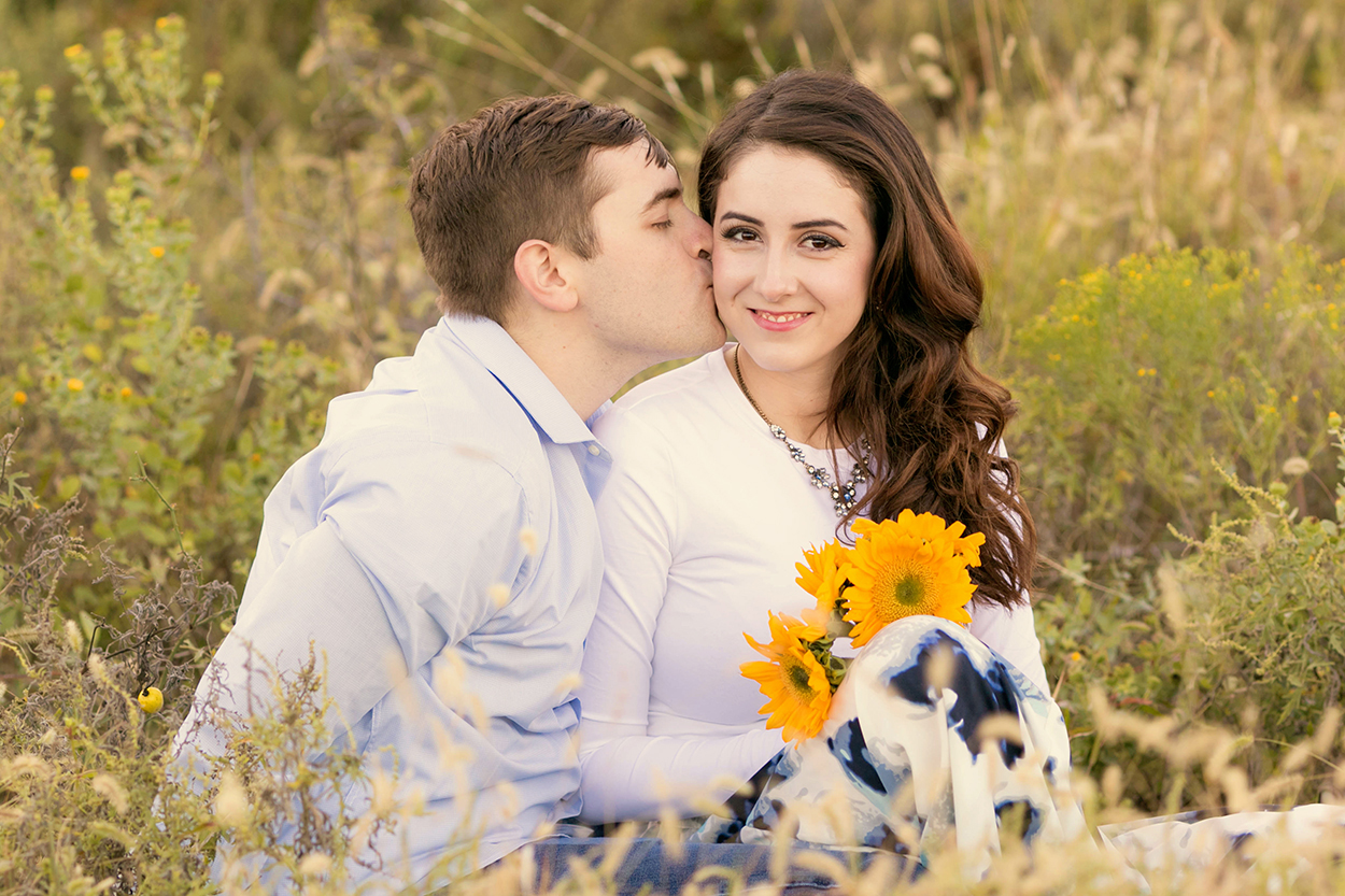 Wildflower Couple sitting in field Engagment.jpg