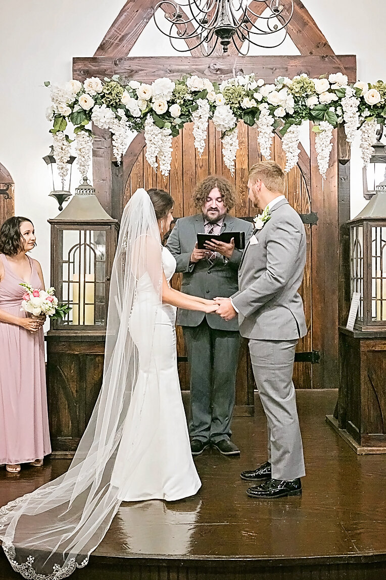 bride and groom at alter with minister- ceremony - parsons wedding- rose briar place- oklahoma city weddings.jpg