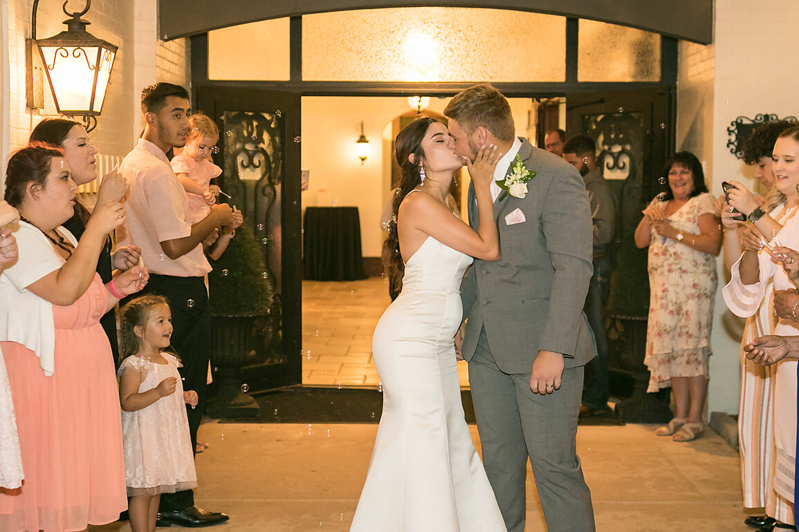 Bride and Groom kissing a farewell- the last goodbye- reception-parsons wedding- rose briar place- oklahoma weddings.jpg