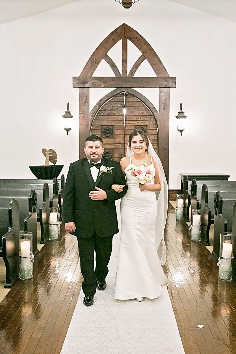 bride walking down aisle on dads arm- ceremony- here comes the bride- rose briar place- oklahoma city weddings.jpg