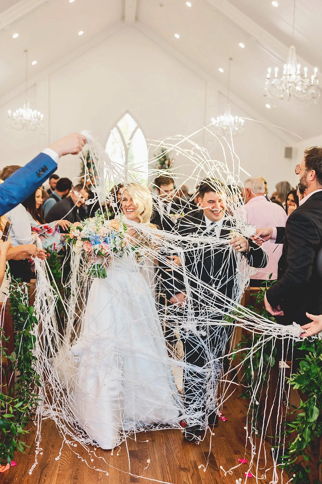 Bride and Groom exiting through streamers JSP Photography.jpg