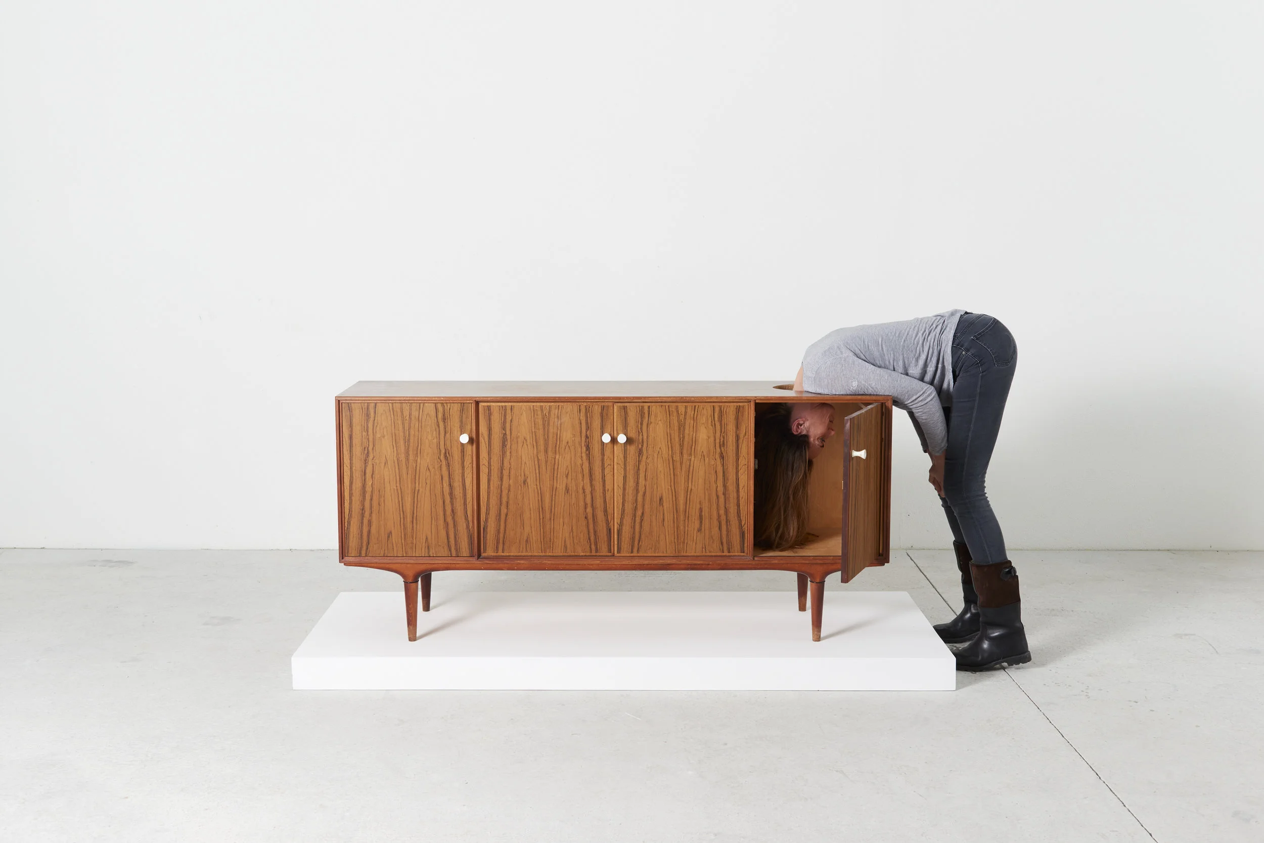 Erwin Wurm, Head TV, One Minute Sculpture, 2016 instruction drawing, Danish cabinet, and realized by public Courtesy the artist and Lehmann Maupin, New York and Hong Kong Photograph/ Eva Wuerdinger