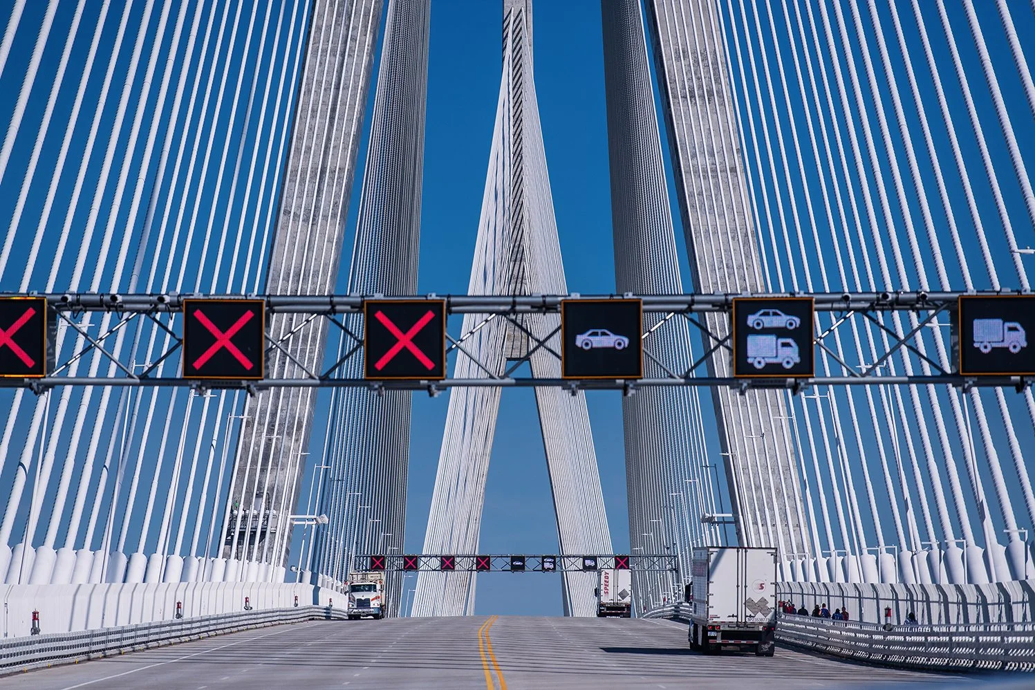 People walking the Gordie Howe International Bridge during the grand opening of pedestrian access between Detroit and Windsor.