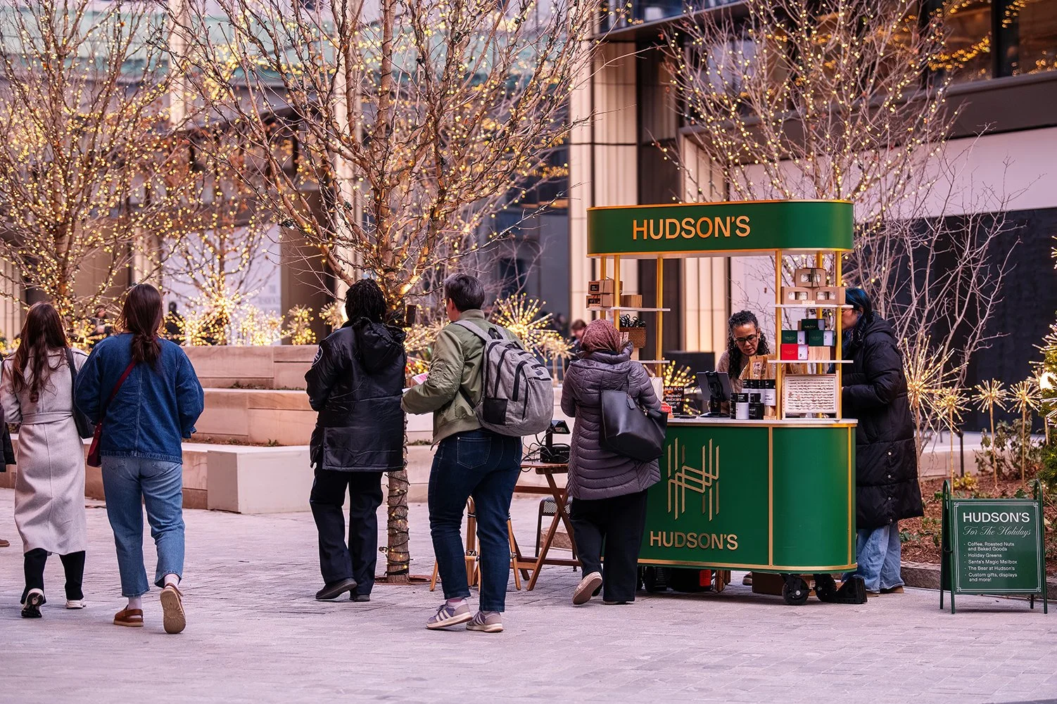  Winter evening crowd at Nick Gilbert Way outside Hudson’s Detroit, a Bedrock development designed by SHoP Architects.  