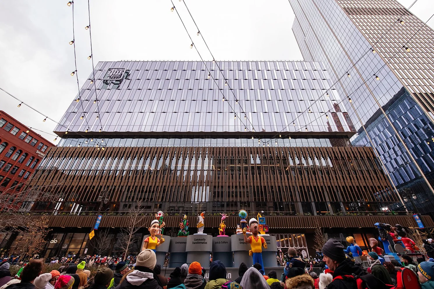   Festive evening scene at Nick Gilbert Way outside Hudson’s Detroit, designed by SHoP Architects for Bedrock.  
