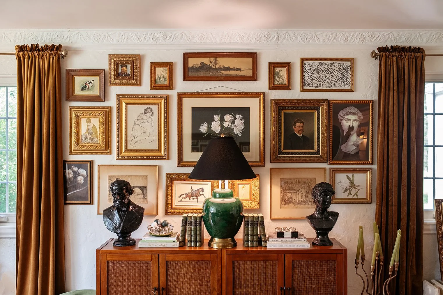 As evening settles in, the living room glows with the timeless atmosphere of a historic Michigan Tudor home, grounding the everyday rhythms of The Gratz Life.