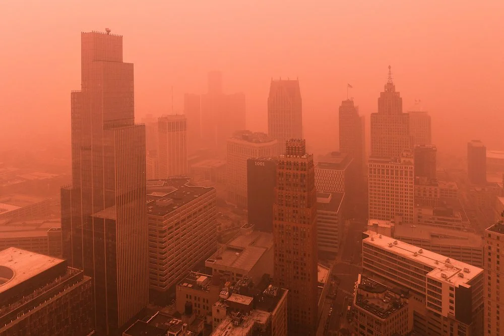 Drone view of the downtown Detroit skyline photographed during hazy conditions created by summer wildfire smoke.