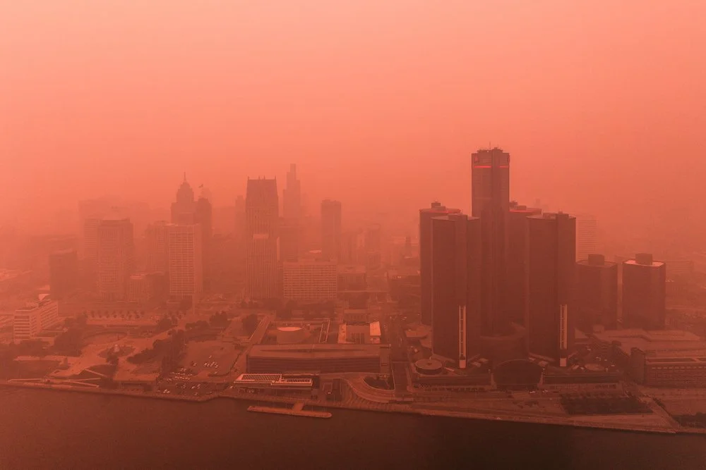 Downtown Detroit architectural skyline photographed by drone during summer wildfire smoke in Michigan.