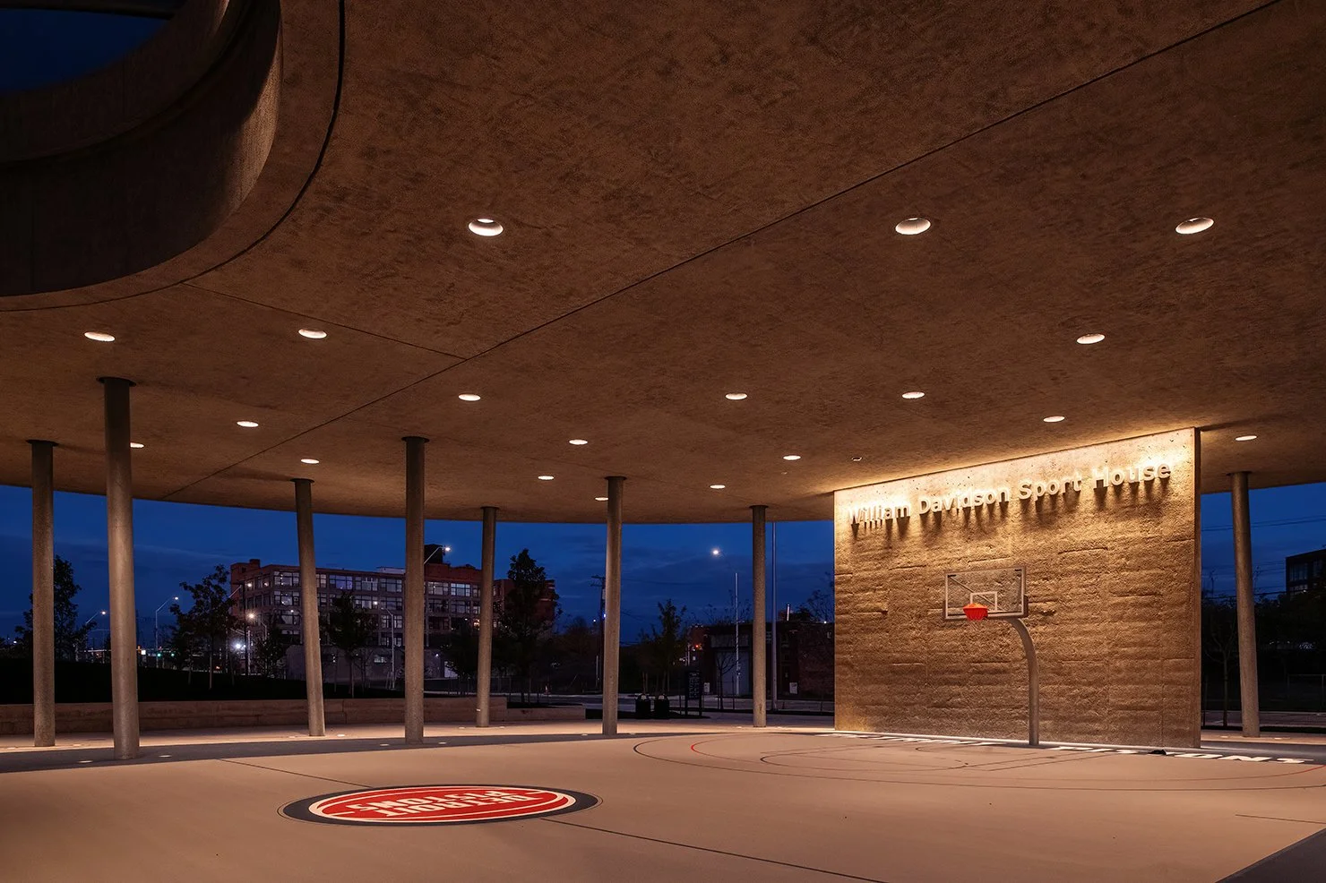 Wide shot of the William Davidson Sport House at Ralph C. Wilson Jr. Park in Detroit, showing the angular canopy designed by Adjaye Associates.