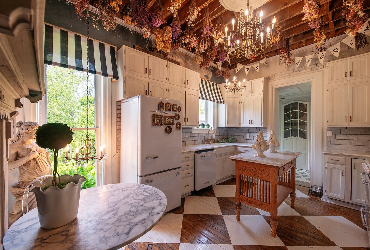 Architectural and interior residential photograph taken of the Iron Victorian for HGTV. This image shows the kitchen looking towards the sink.