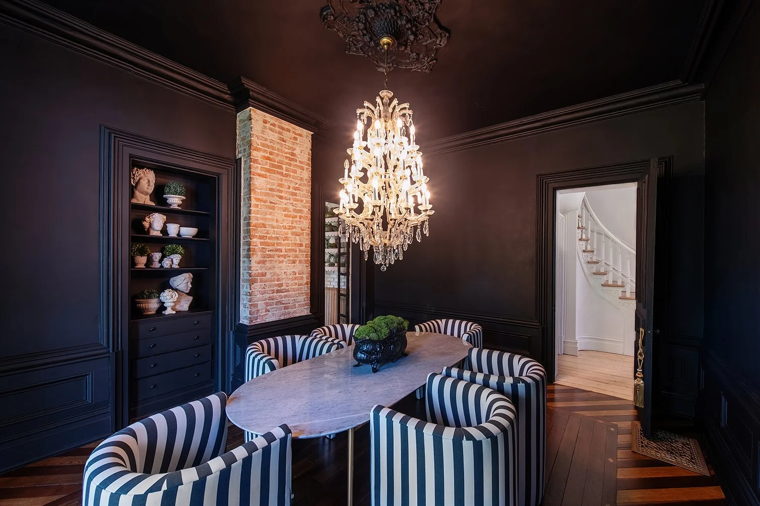 Architectural and interior residential photograph taken of the Iron Victorian for HGTV. This image shows the dining room looking back towards the entryway.