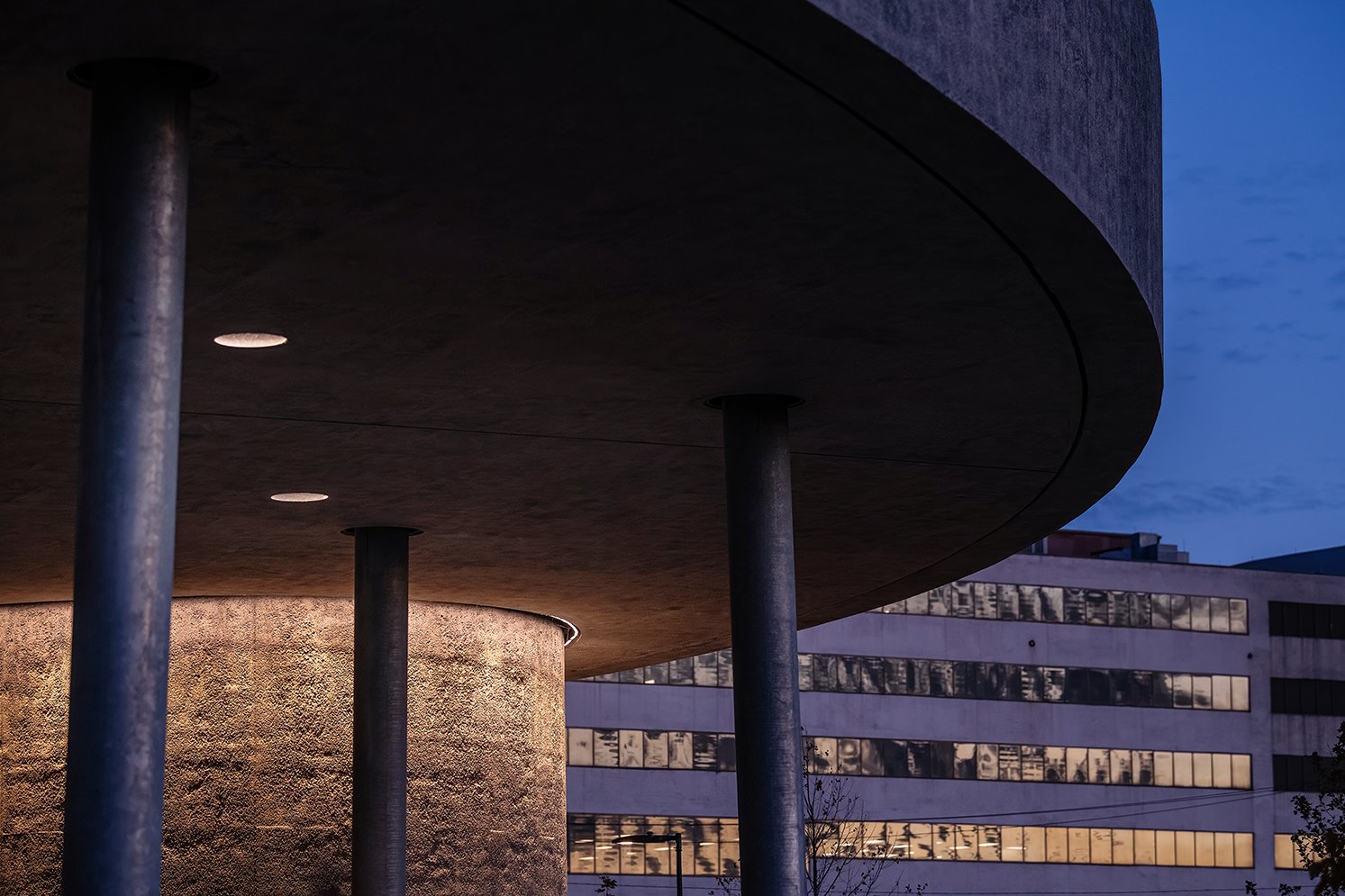 Angled concrete columns supporting the William Davidson Sport House in Detroit, highlighting the structural design by Adjaye Associates.