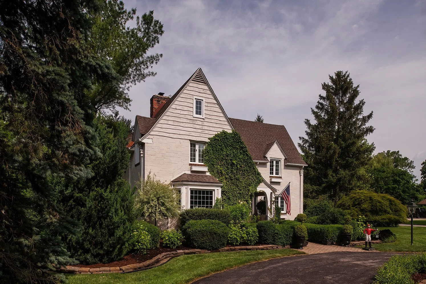 An exterior photograph of a historic Tudor home in Michigan, setting the scene for the timeless atmosphere and story behind The Gratz Life.