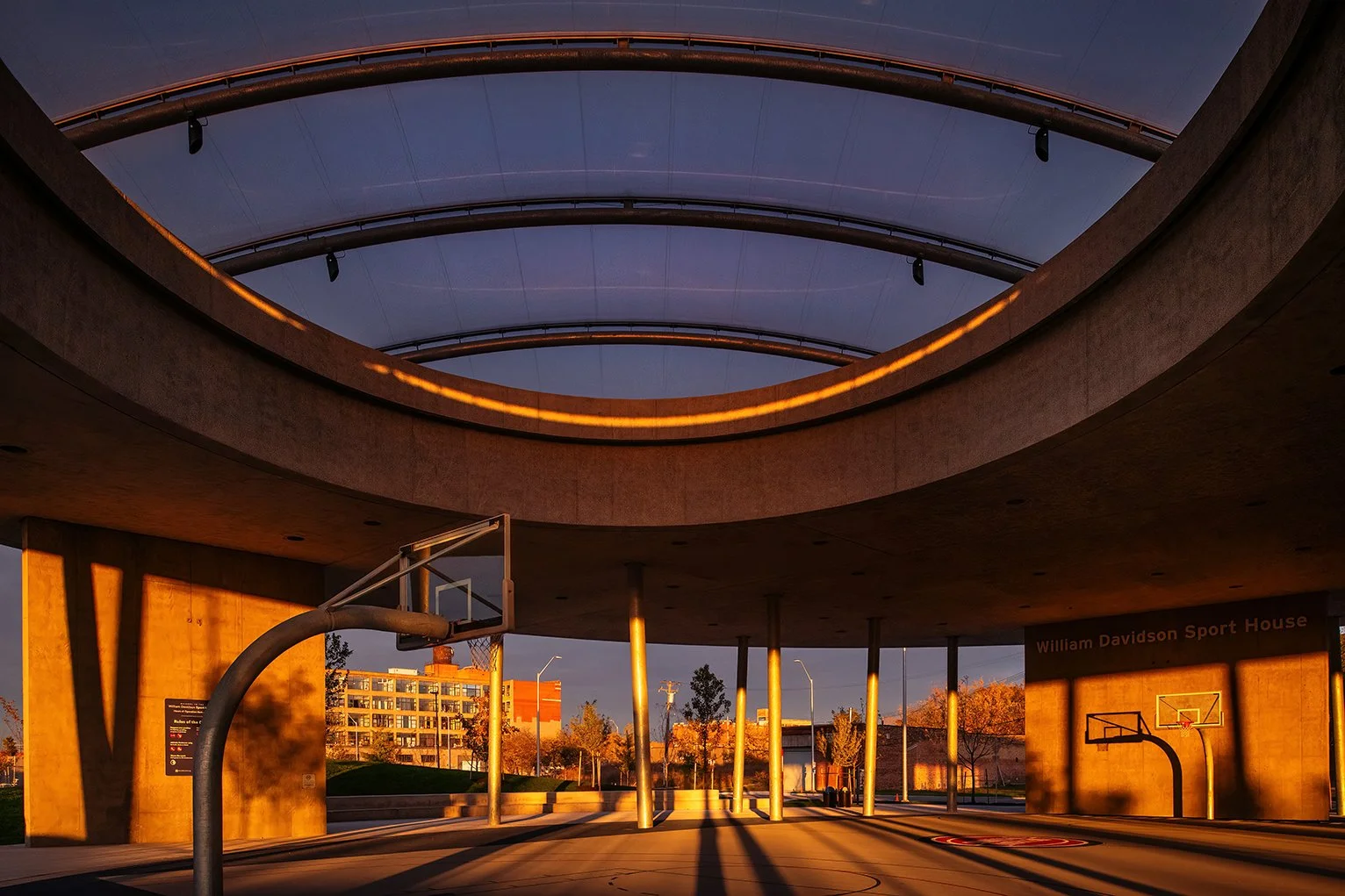 Interior perspective of the sports courts at the William Davidson Sport House in Detroit, with natural light entering through the roof designed by Adjaye Associates.