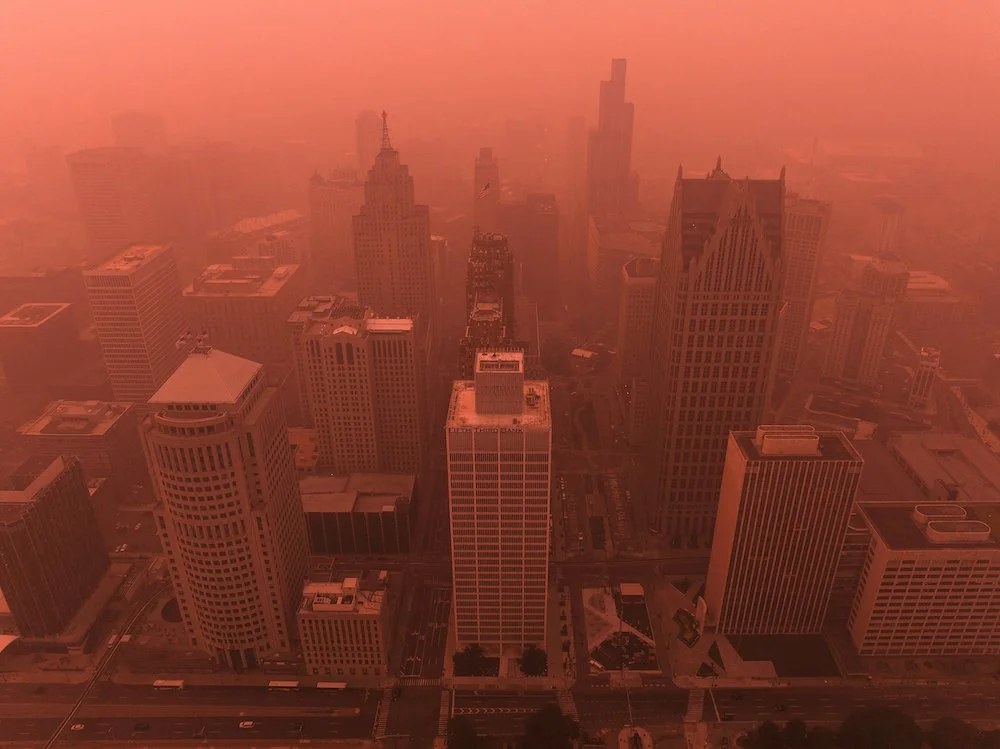 High-altitude drone photograph of downtown Detroit documenting the city's architecture under smoky skies.