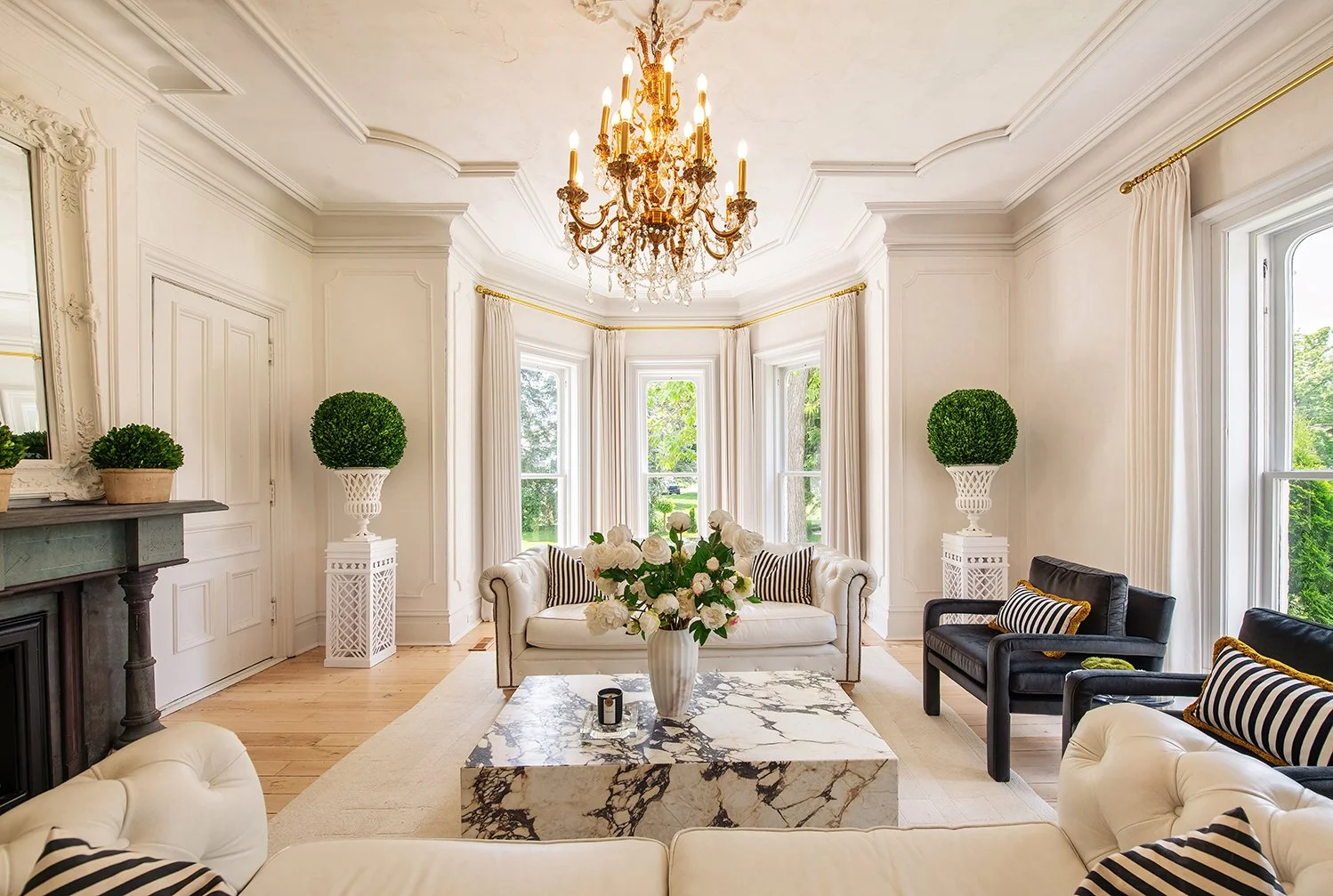 Architectural and interior residential photograph taken of the Iron Victorian for HGTV. This image shows the living room with the fireplace to the left.