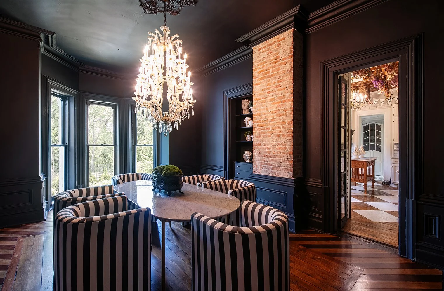 Architectural and interior residential photograph taken of the Iron Victorian for HGTV. This image shows the dining room looking out towards the yard.