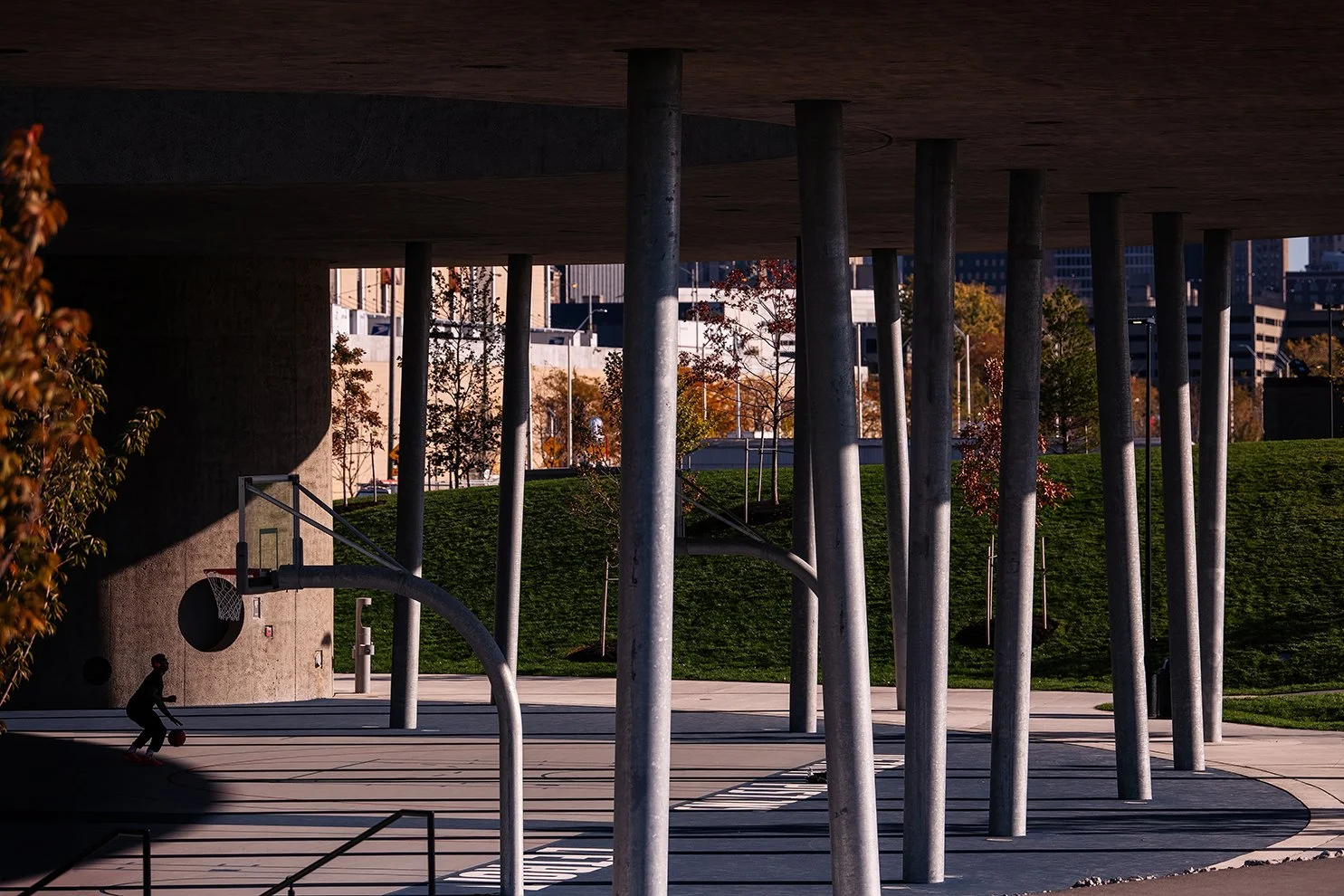 People using the basketball courts at the William Davidson Sport House in Detroit, demonstrating the community-focused design by Adjaye Associates.