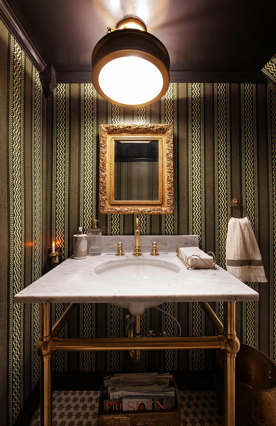 A powder room shaped by time, blending Tudor tradition with an elevated, lived-in feel, captured in this Michigan home by The Gratz Life.
