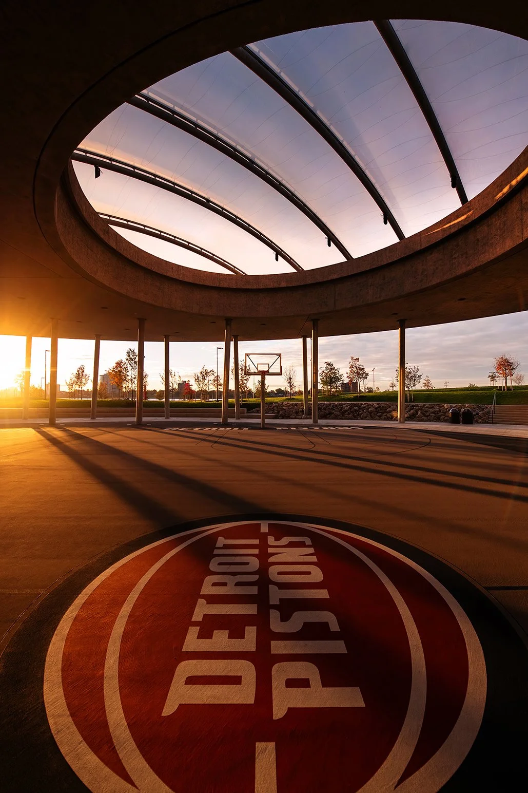 Courtside view of the William Davidson Sport House in Detroit, illustrating the indoor-outdoor pavilion concept designed by Adjaye Associates.