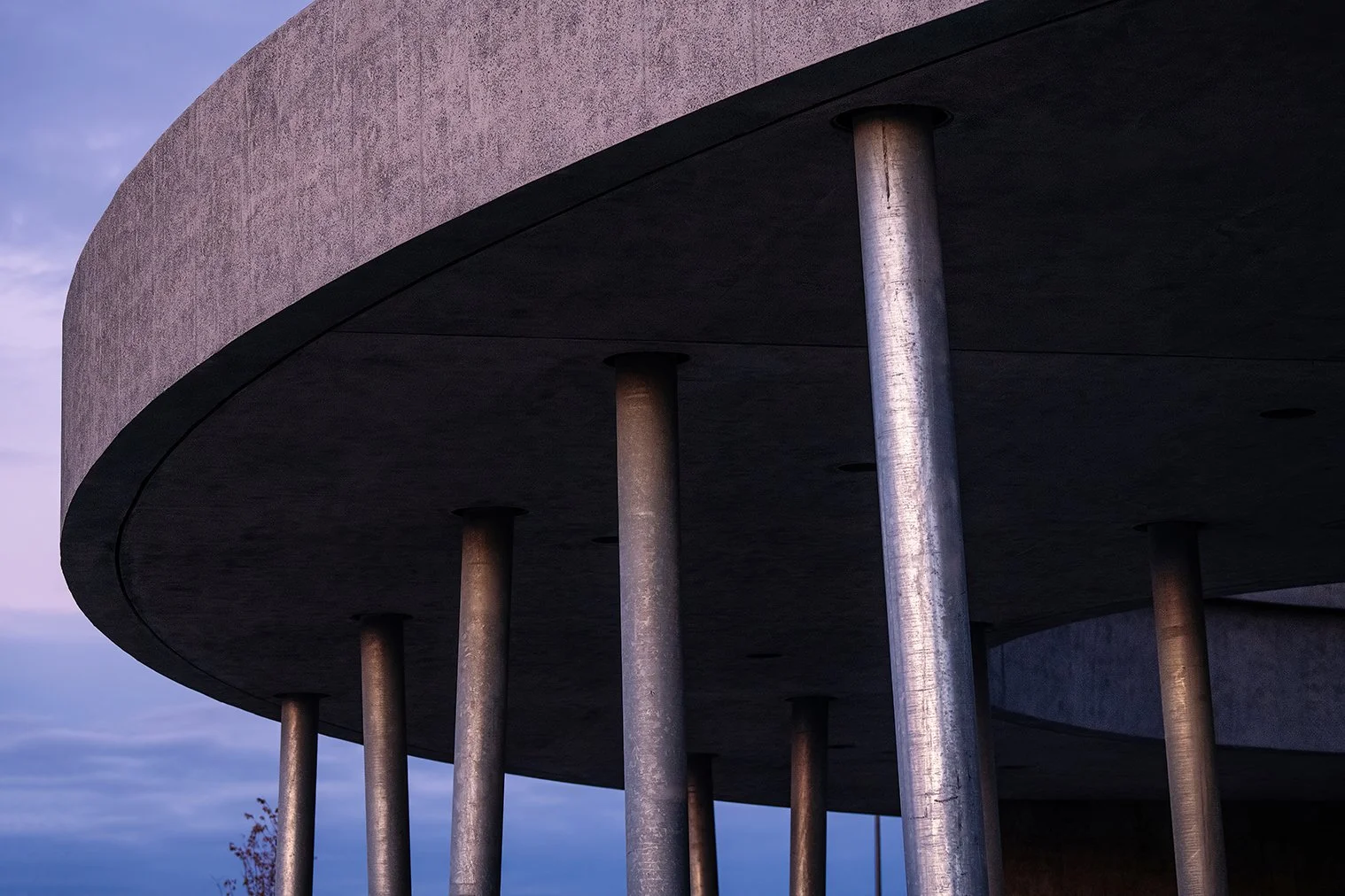 View beneath the canopy of the William Davidson Sport House in Detroit, showing the open-air basketball courts designed by Adjaye Associates.