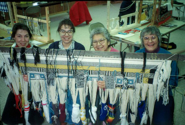 Lani Hotch, second from left, works with her community on the Klukwan Healing Robe .