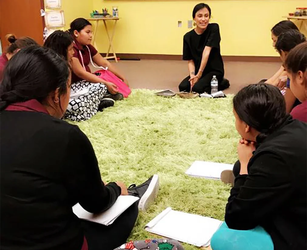 Laree Pourier (Oglala Lakota) leads a workshop with the girls at Anpo Wicahpi. 