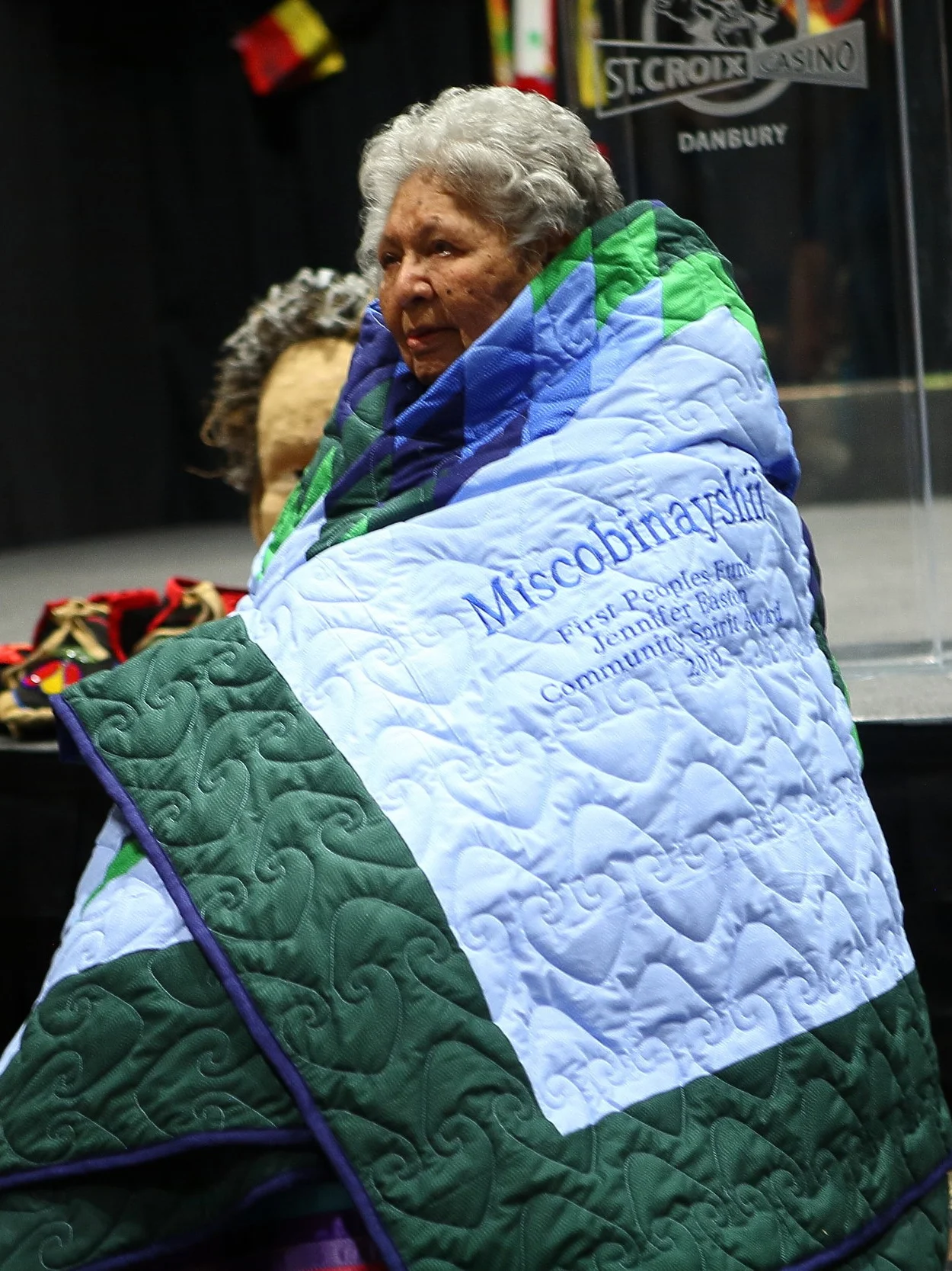 Miscobinayshii wrapped in her star quilt from FPF. Photo by Falls Portrait Art Studio.