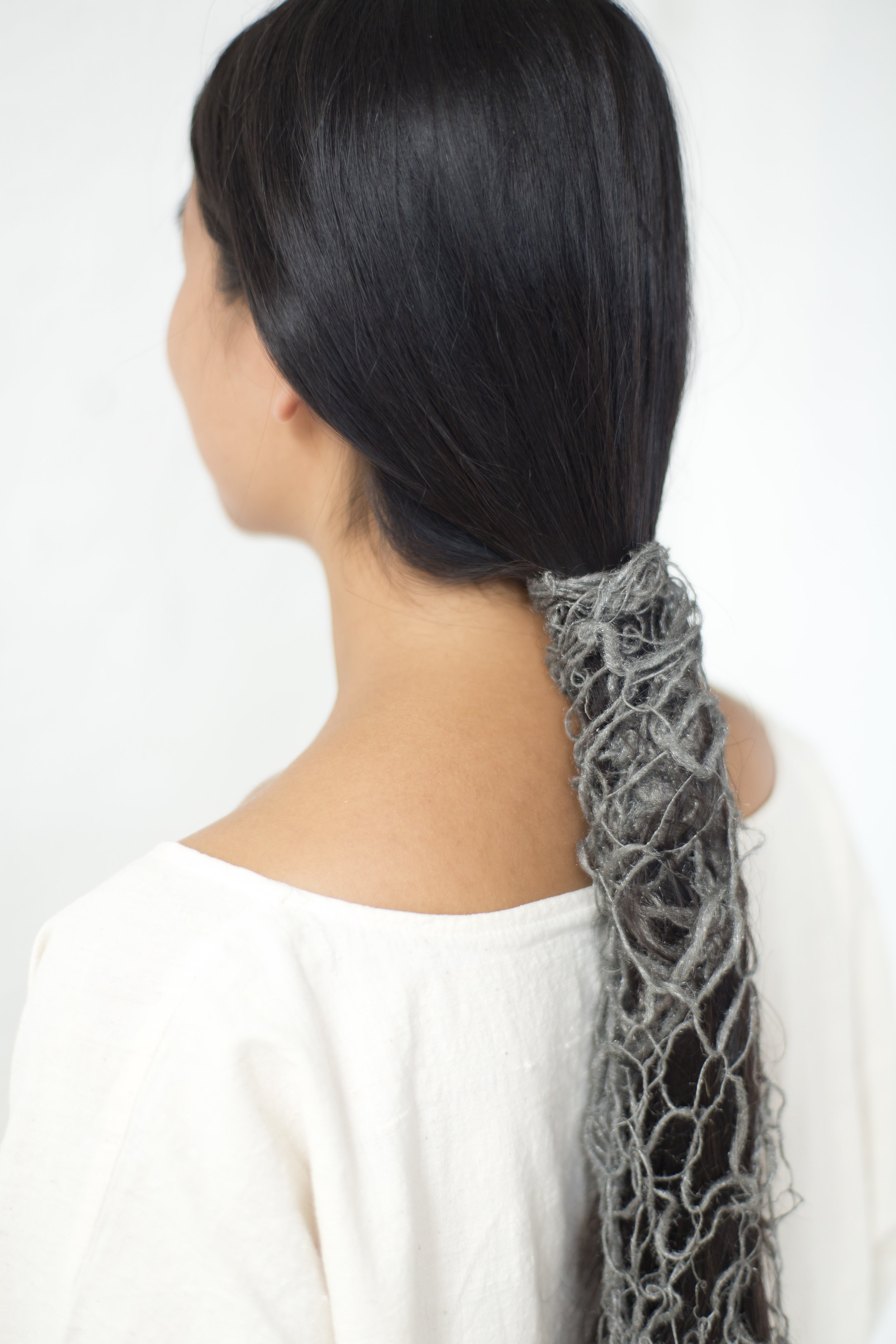 A detail photograph of the steel wool blanket wrapping around the artist's hair. 