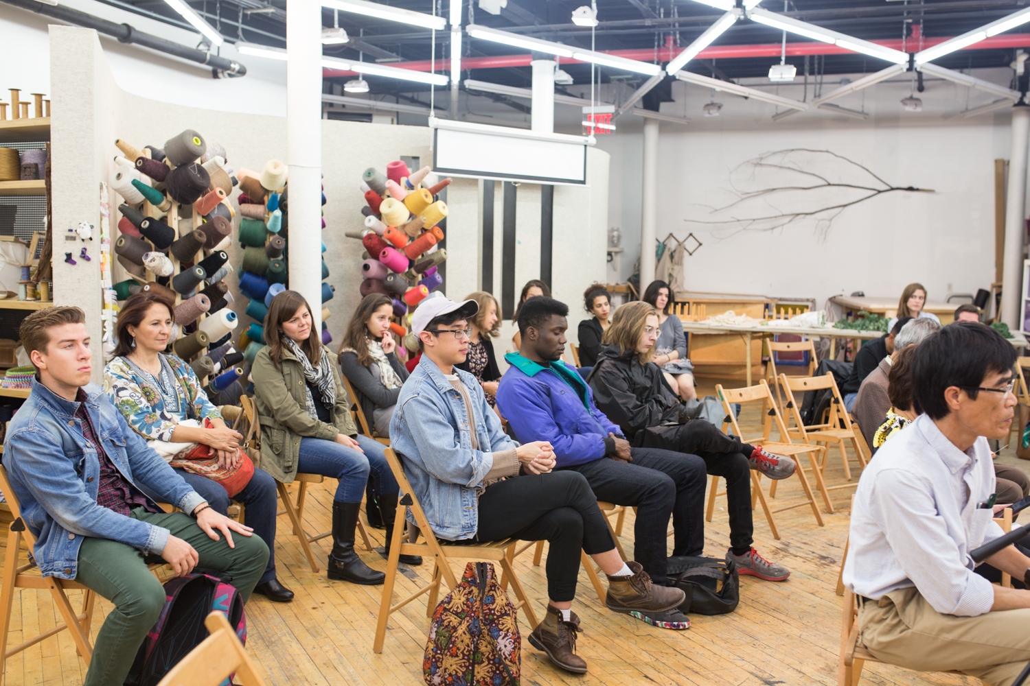The room is filled with audience members as they watch the performance intently.