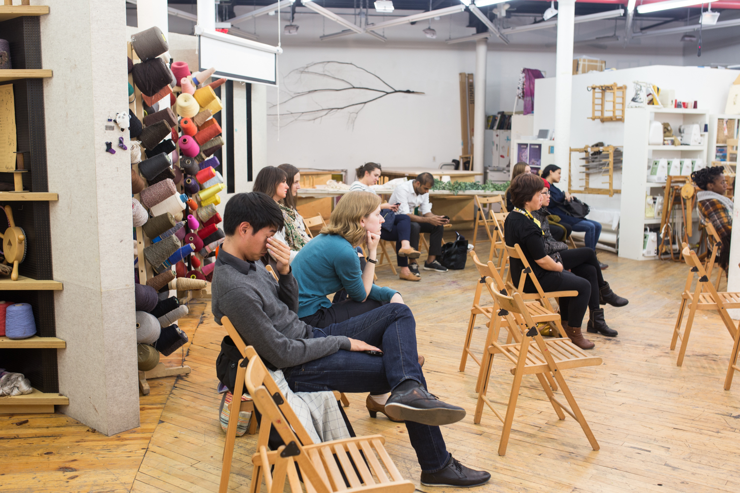 A different group watches the performance. One audience member is rubbing their eyes.