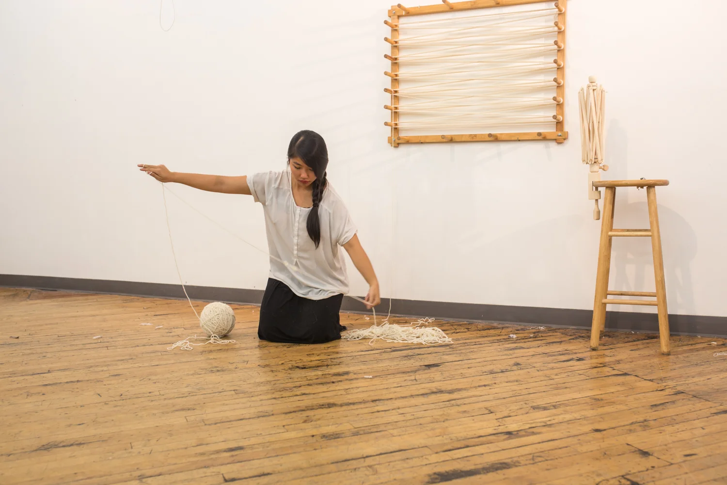 The artist focuses on untangling a knot.