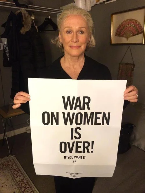 Actress Glenn Close holding the "War on Women is Over! If You Want It" poster
