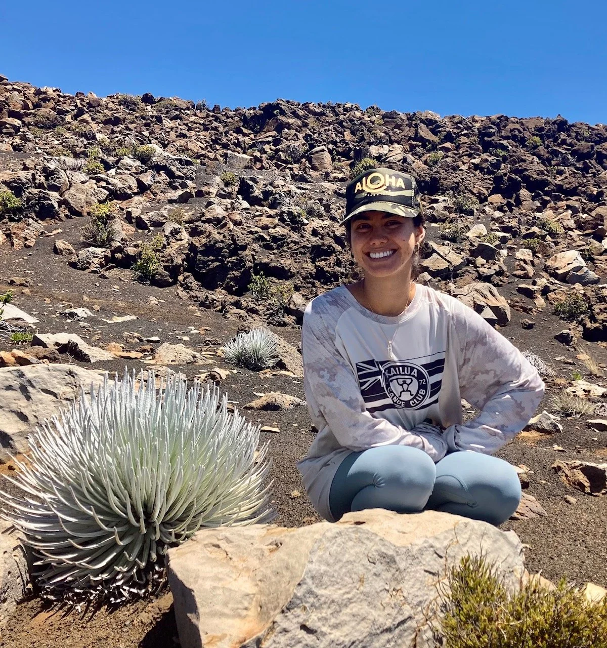  Emma Piianaia at the Haleakalā Summit, with her plant of study,  Argyroxiphium sandwicense  subsp.  macrocephalum  (ʻĀhinahina) 