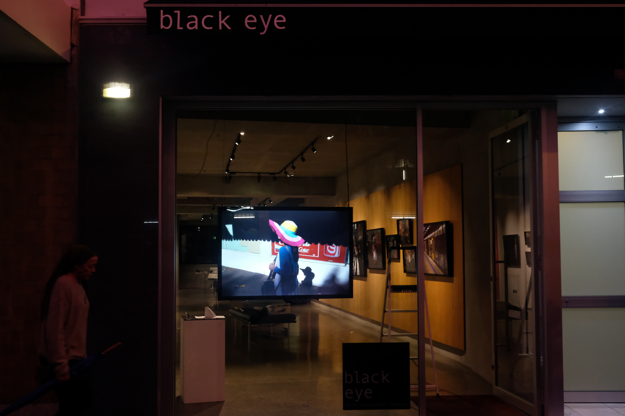  Front of Black Eye gallery, Greg Marsden's iconic 'Hat Lady' image adorns the window as a duratrans print displayed in a lightbox 