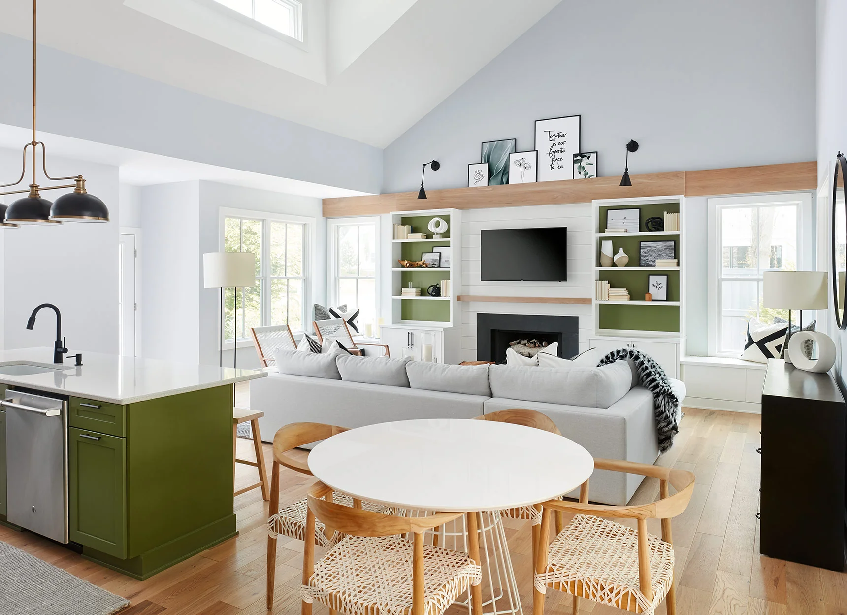 Across from the kitchen, we incorporated custom built-ins to make the space feel cohesive and to provide storage, additional seating, and most importantly, celebrate the fireplace and ceilings!
