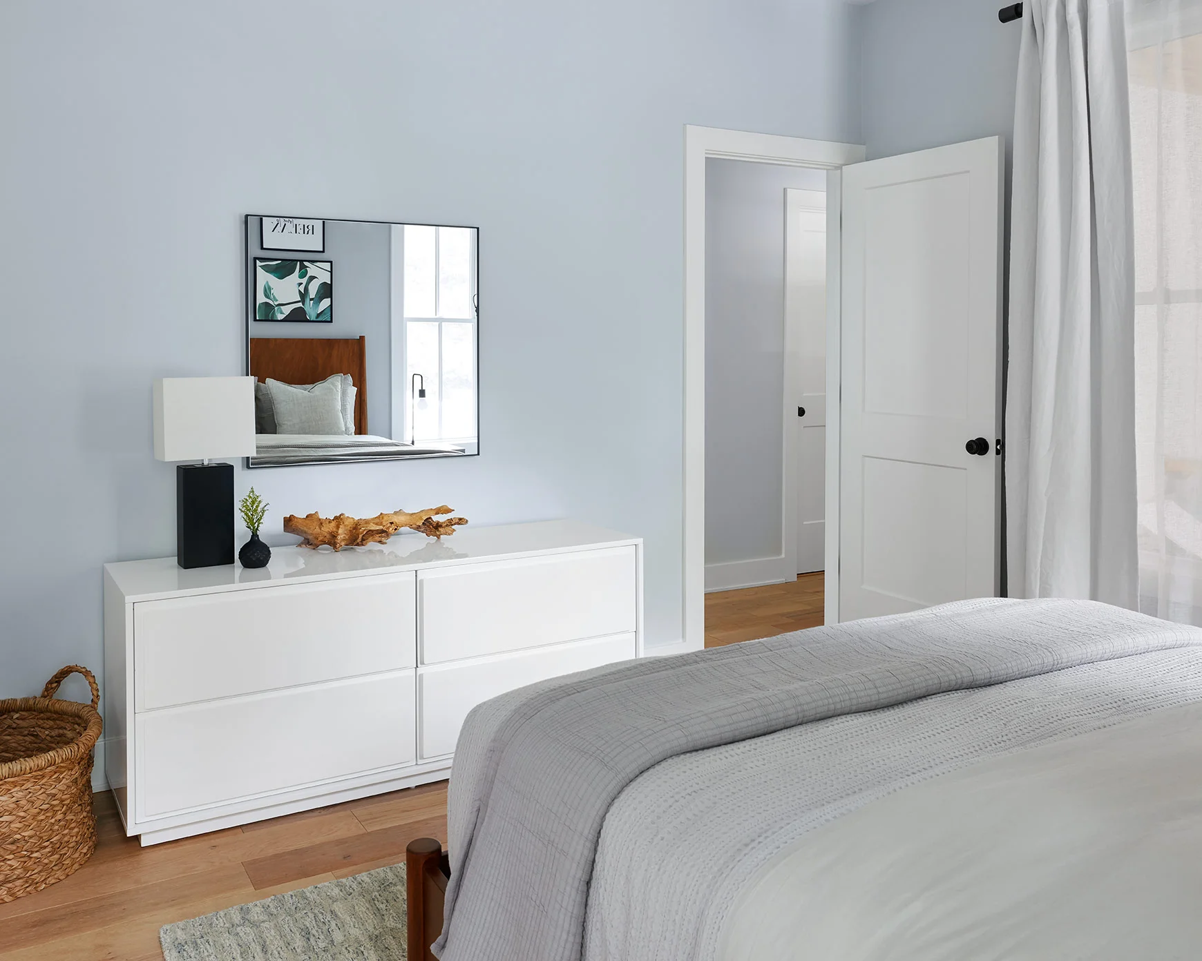 Opposite the bed, a crisp white lacquer dresser completes the room with natural textures to add contrast and interest.