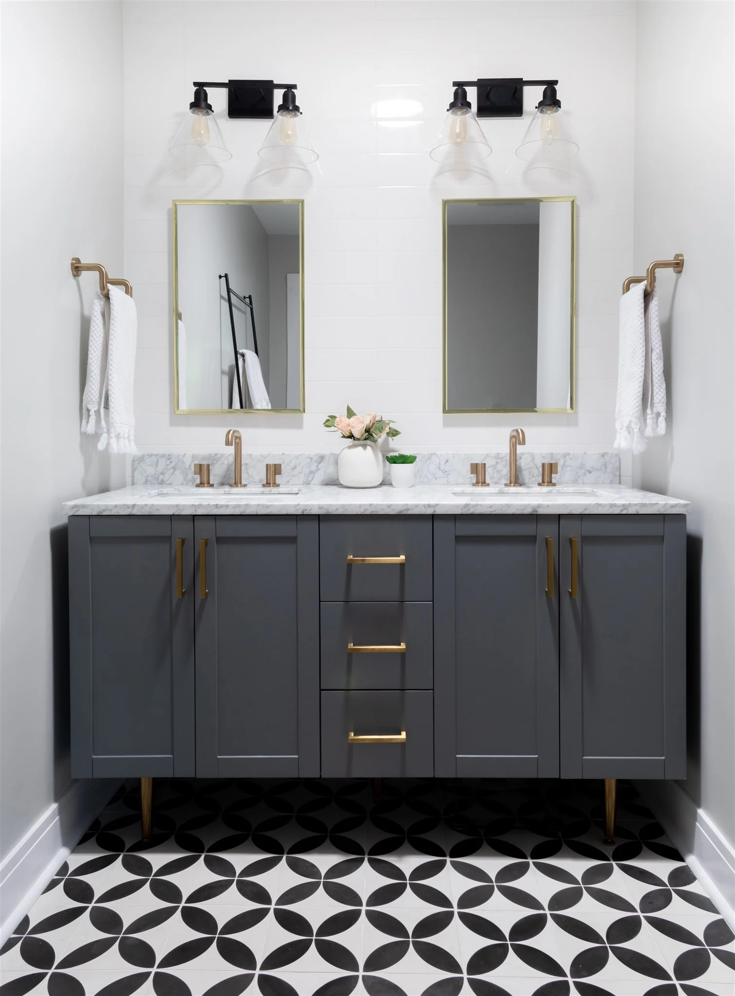 Behind the vanity and in the shower, we installed long subway tiles to give a modern yet familiar feel and add a soft touch to balance out the bold floor tiles.