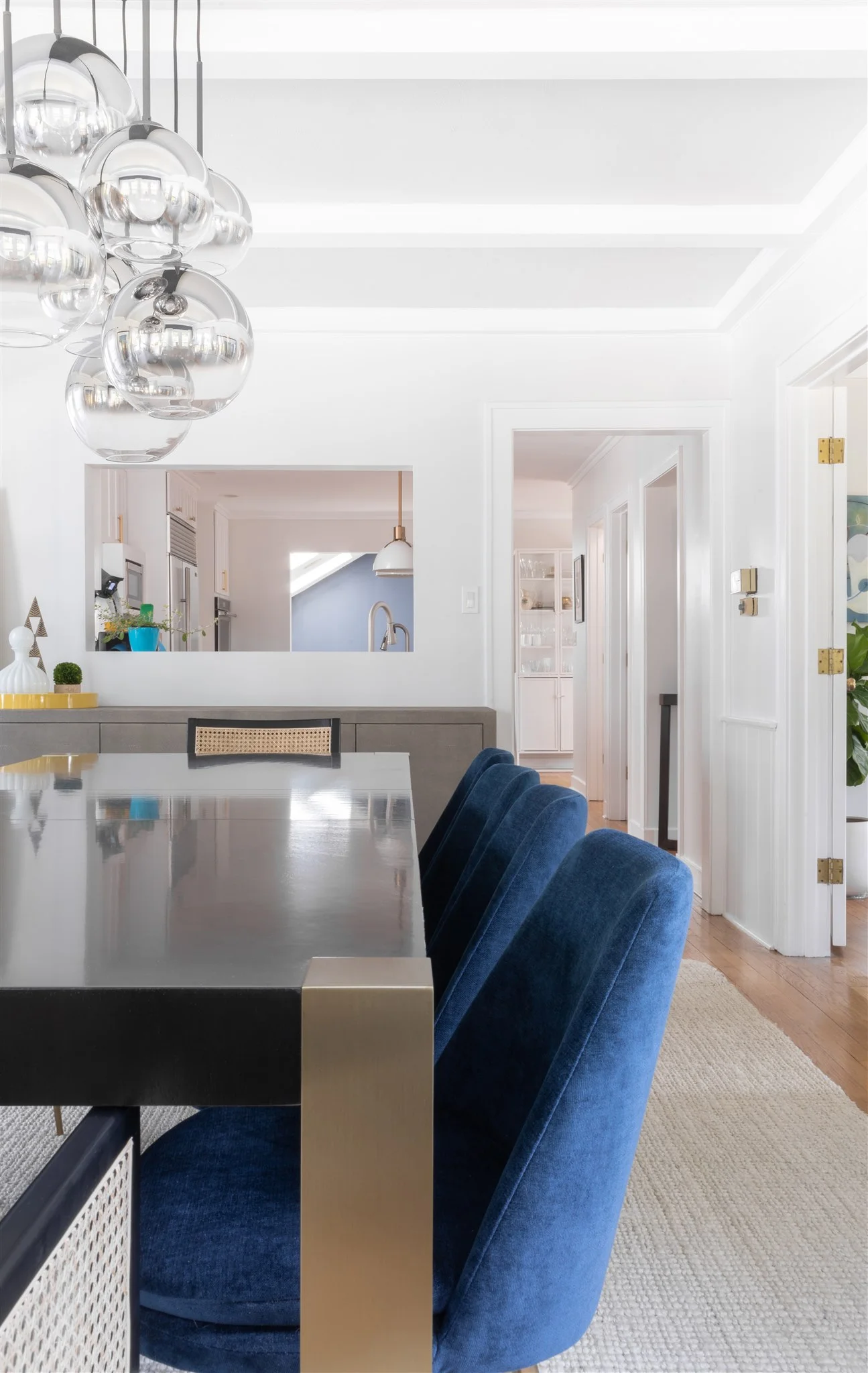 One unique detail in this home is that there are large cutouts between the rooms, allowing for separate spaces that are also tied together. We carried the same navy accent walls throughout to create a cohesive feel and add some contrast.