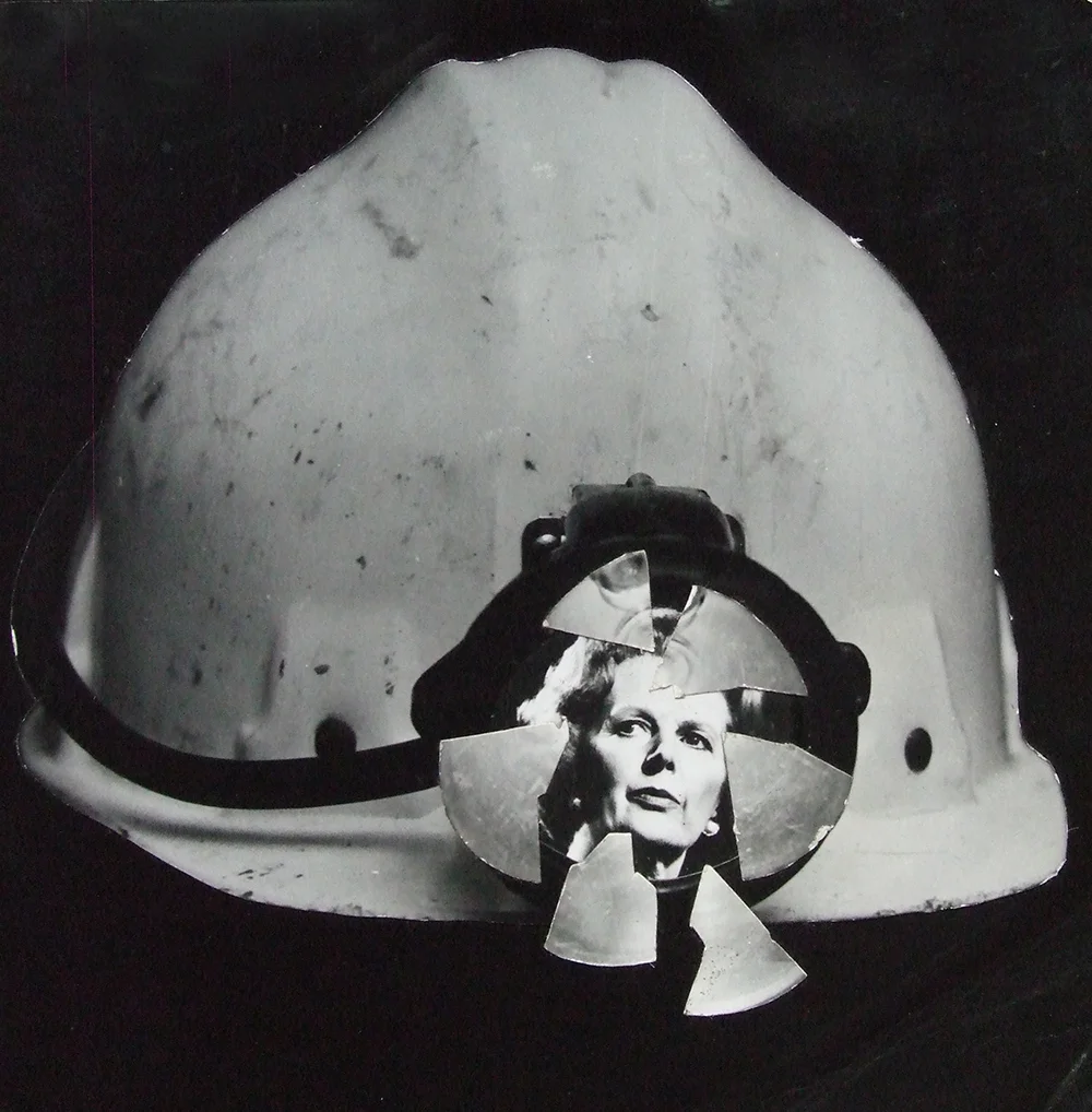 Thatcher Smashes through a miner's helmet.jpg