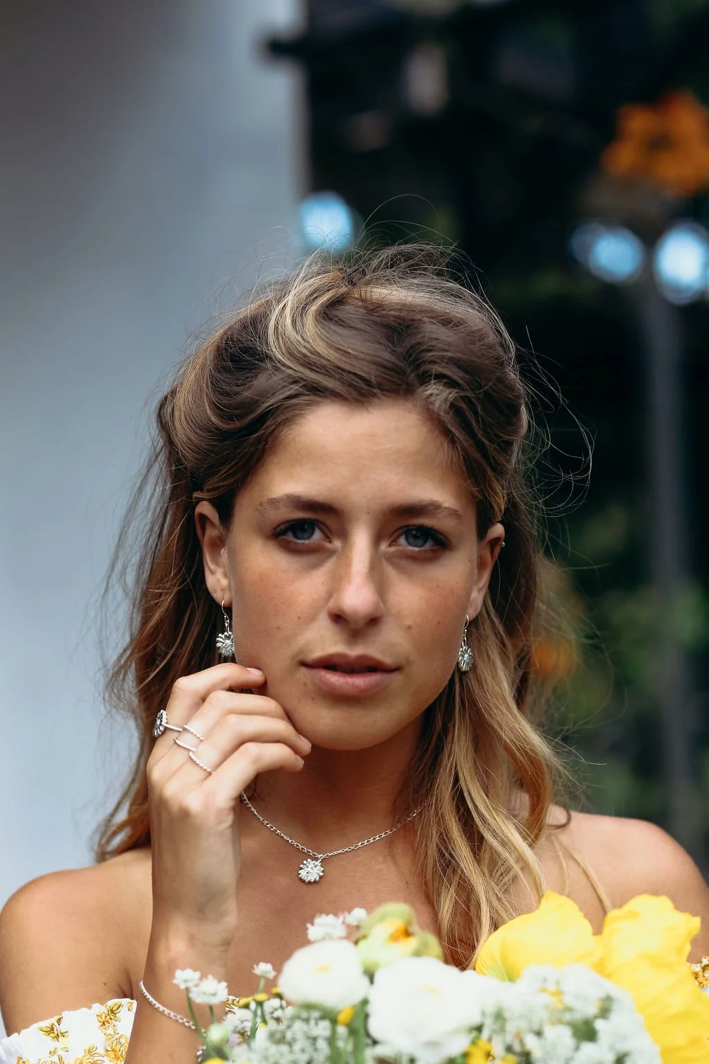 silver-daisy-earrings-model-two-in-the-sun.jpeg