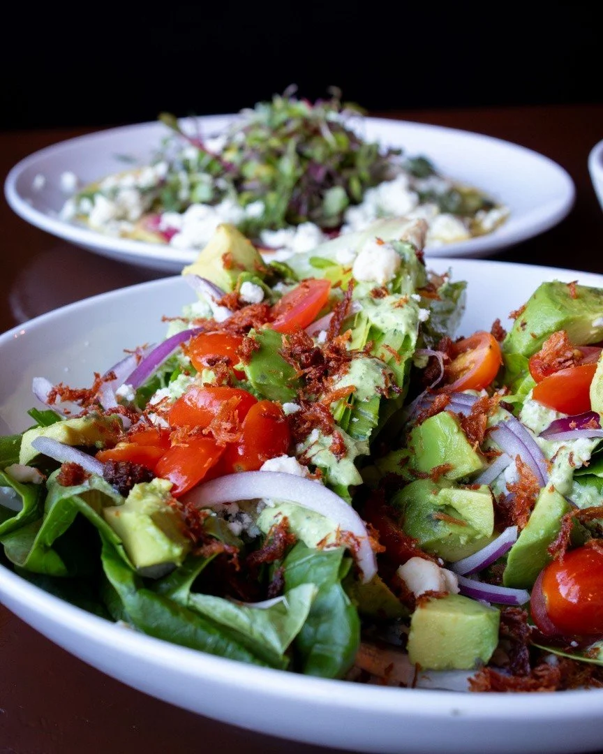 Our Wedge Salad. Romaine, smoked blue cheese, red onion, grape tomatoes, avocado, bacon, and green goddess dressing. 🥗 

Add chicken or brisket. Or go big with seared yellowfin tuna.