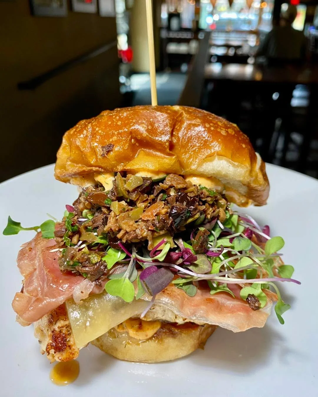 Our special this week is a Serrano Chicken Sandwich. 
Grilled chicken breast, Serrano ham, manchego cheese, smoked paprika aioli, olivada, and micro greens on a pretzel bun. $18 available 7/23-7/28

Our Wing flavor today is a Sticky Sriracha served o