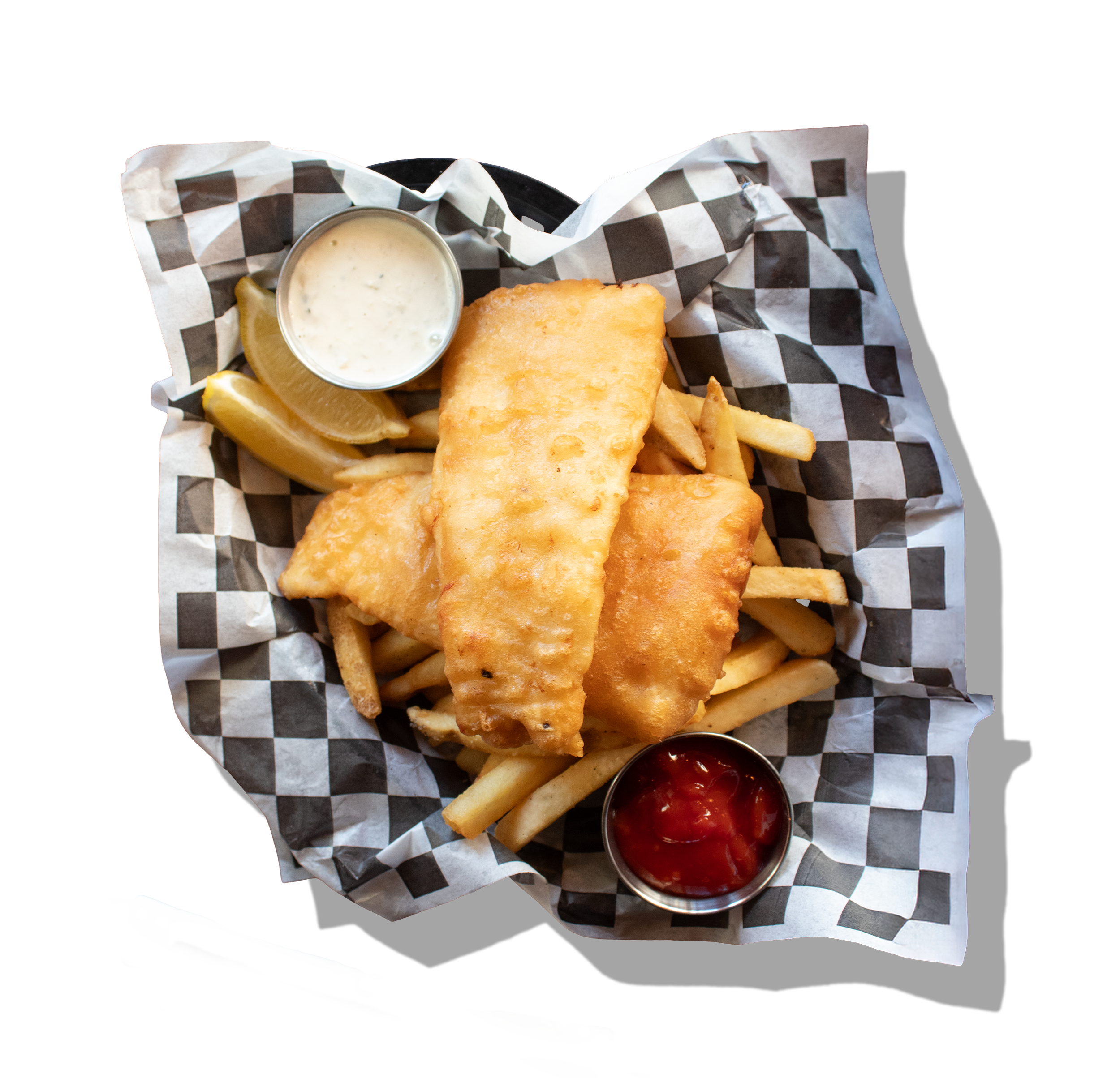 Battered fish fillets with French fries, lemon wedges, tartar sauce, and ketchup in metal cups on checkered paper-lined basket.