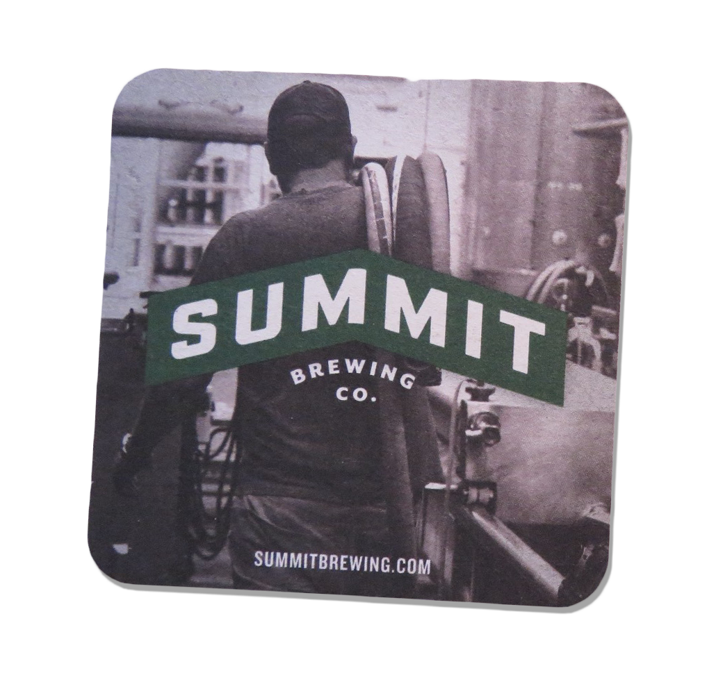 A black and white photograph of a person with short hair carrying a backpack, standing with their back to the camera in a brewing environment. The image features a green banner across the center with the white text "SUMMIT" and smaller text "BREWING CO." Below, the website URL "SUMMITBREWING.COM" is visible.