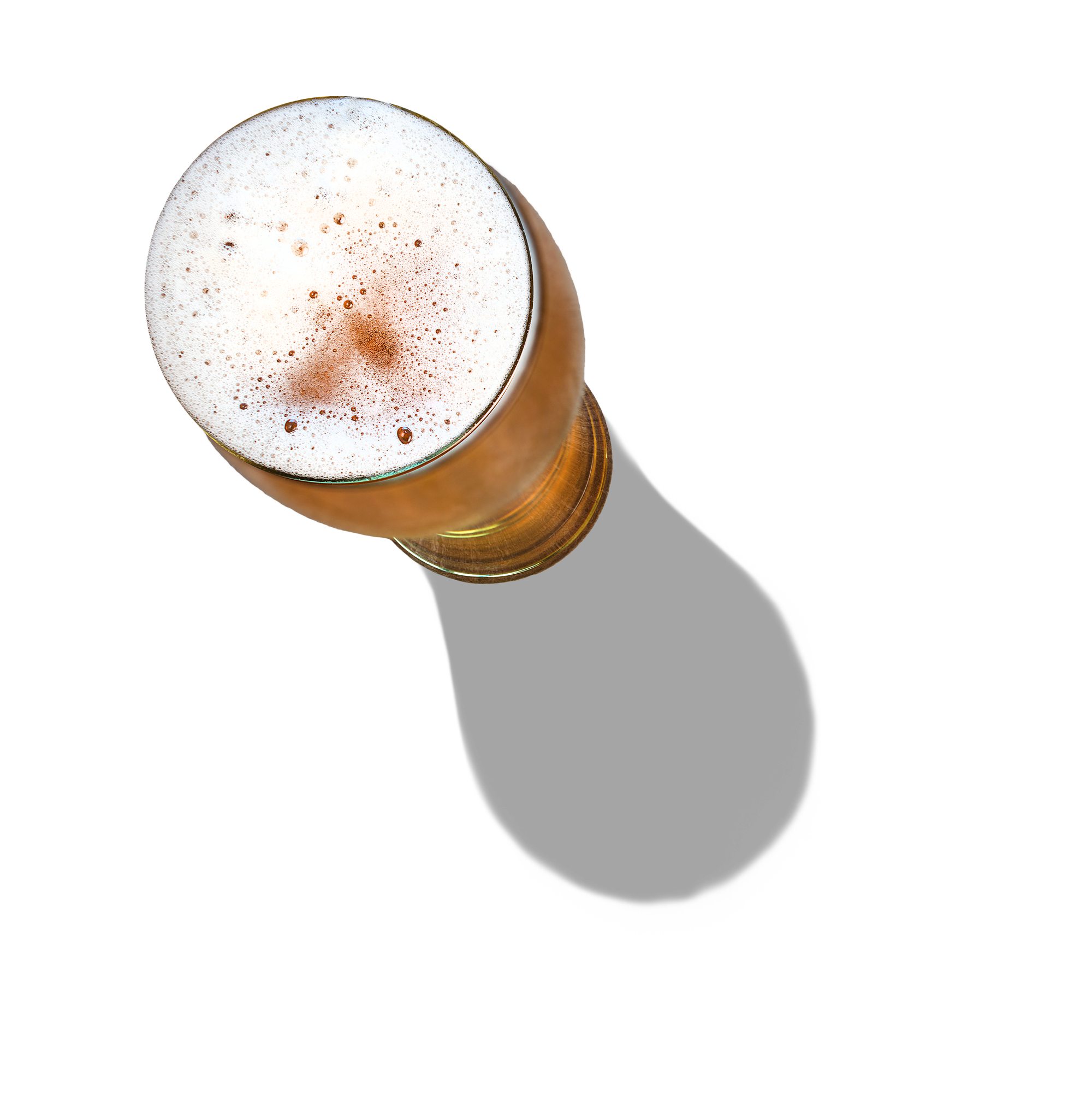 Top view of a foamy glass of beer with a brownish color on a black background.